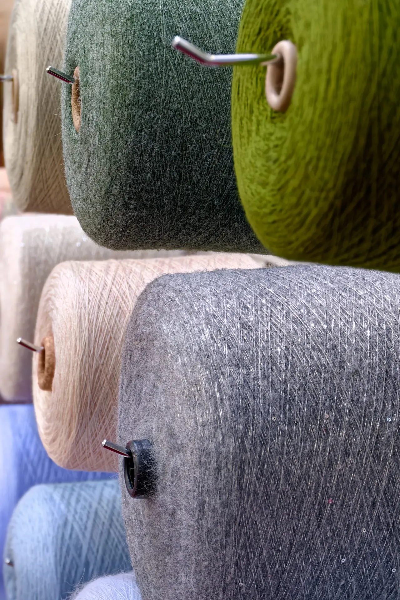 Assorted spools of multi-colored wool threads